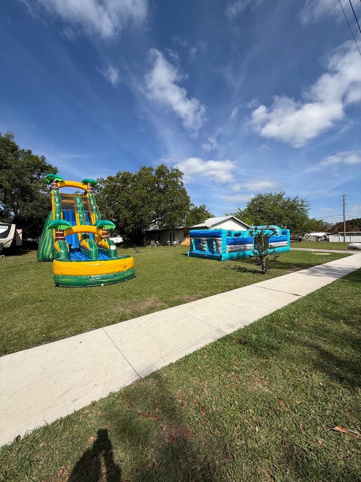 The wide shot of an inflatable water slide setup at a school event.